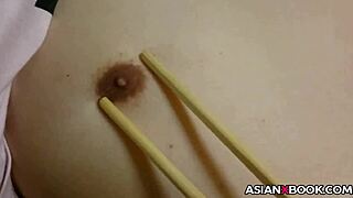 In a homemade setting, an Asian babe skillfully uses chopsticks for an intense handjob session with her amateur partner.