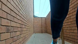 risky ebony woman flashes outdoors