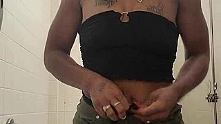 Ebony amateur pees in public bathroom trash with worker in adjacent stall