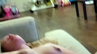 I watch lollipop milf pleasure herself on the couch with a dildo, her blue eyes sparkling behind glasses as she uses toys