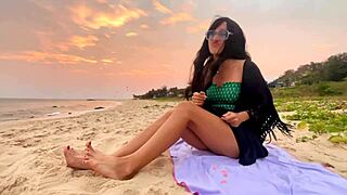 A beautiful girl with long hair chases sunsets on the beach, feeling pure joy.