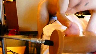 guy uses machine to fuck his ass in gay scene.