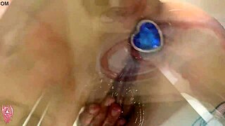 a cute girl teases with wet buttplug