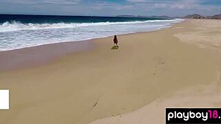 Busty inked babe strips down in bikini on beach