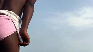 On the seaside, twerking energetic woman wears attractive outfit