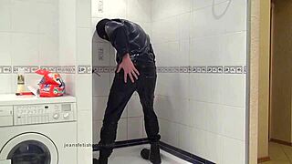 The master in blue jeans washes himself in the bathroom