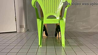 maid cleans in pvc outfit while dangling shoes