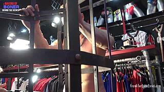 Threesome action unfolds in a gay store setting.