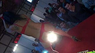 In an outdoor public setting, the devil and angel engage in erotic blowjob and masturbation under voyeur eyes