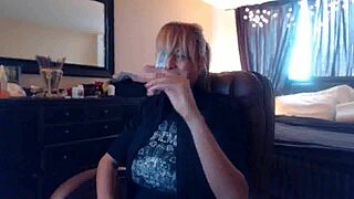 Sandi smokes cigarettes while her big tits squirt in fetish play