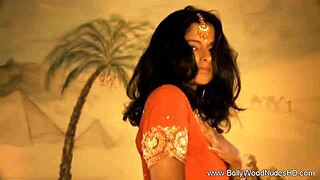 Oriental beauty dances sensually to showcase her exotic charm in nude performance.