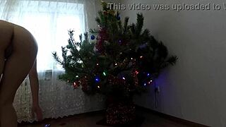 bitch with small tits dances around christmas tree showing ass and pussy