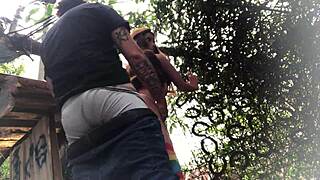 Is the redhead's ass getting fucked outdoors with a sex toy?