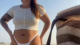 Redhead Exhibitionist Flashes Swollen Pussy On Beach While Muscular Man Receives Sloppy Blowjob