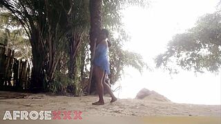 A black-skinned girl is having some fun on the beach, teasing everyone