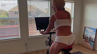 Blonde muscular milf strips down after Peloton workout revealing big ass and clit.
