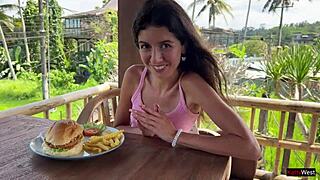 Skinny brunette flashes tight pussy in public cafe then gets facial from waiter.