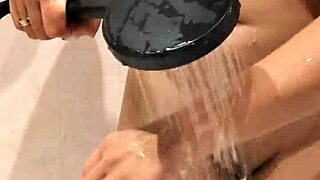 Milf gets naked in the shower, revealing big tits while bathing sensually in private moment.