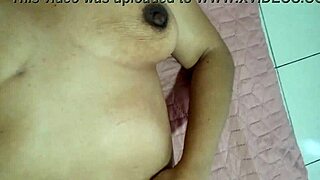 consented woman caresses intimate parts softly rubbing clit feeling excited itch in bedroom solo.