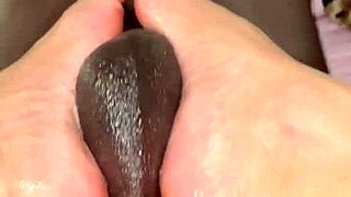 giving foot massage to muscular guy with my feet