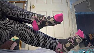 hey there, check out this milf stripping barefoot, flashing tattooed ass, black piercing, natural tits, and feet in socks